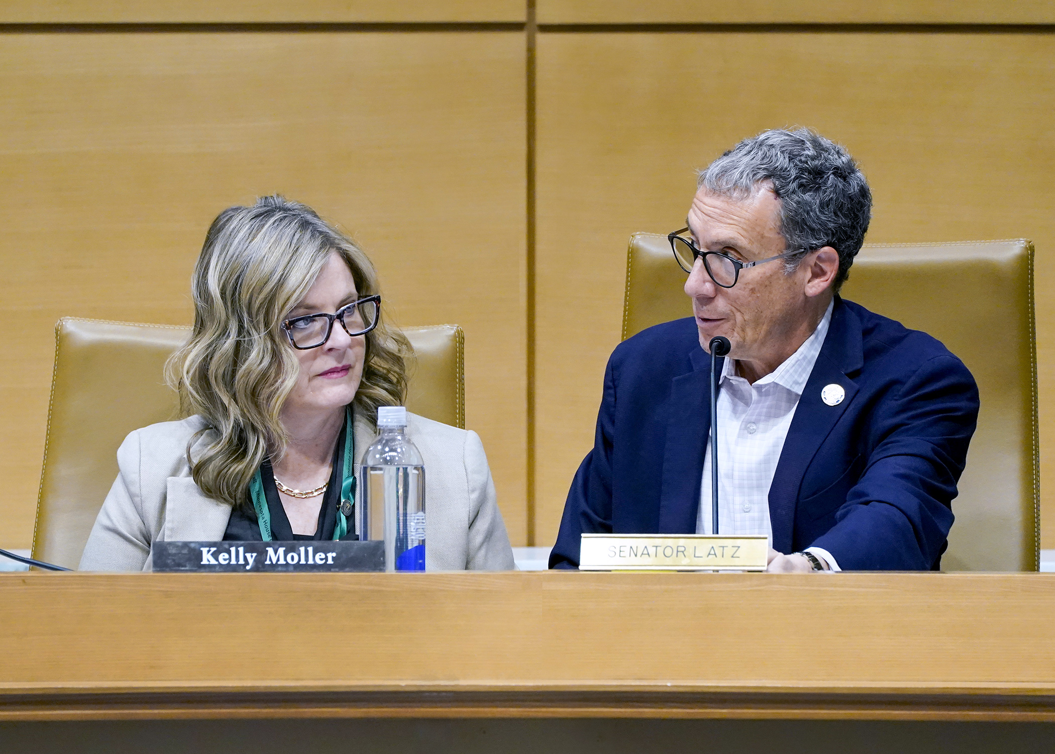 Rep. Kelly Moller and Sen. Ron Latz confer May 13 before the start of the conference committee on HF3230/SF3432* that would provide additional safety and security measures for the judicial branch, House and Senate. (Photo by Andrew VonBank)